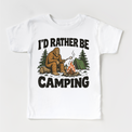 I'd Rather Be Camping Bigfoot roasting a marshmallow by a campfire on a white short sleeve tee
