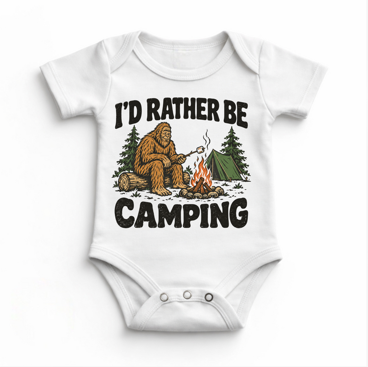 I'd Rather Be Camping Bigfoot roasting a marshmallow by a campfire on a white baby bodysuit