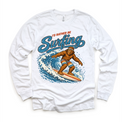 I'd Rather Be Surfing Bigfoot riding a wave design on a white long sleeve tee