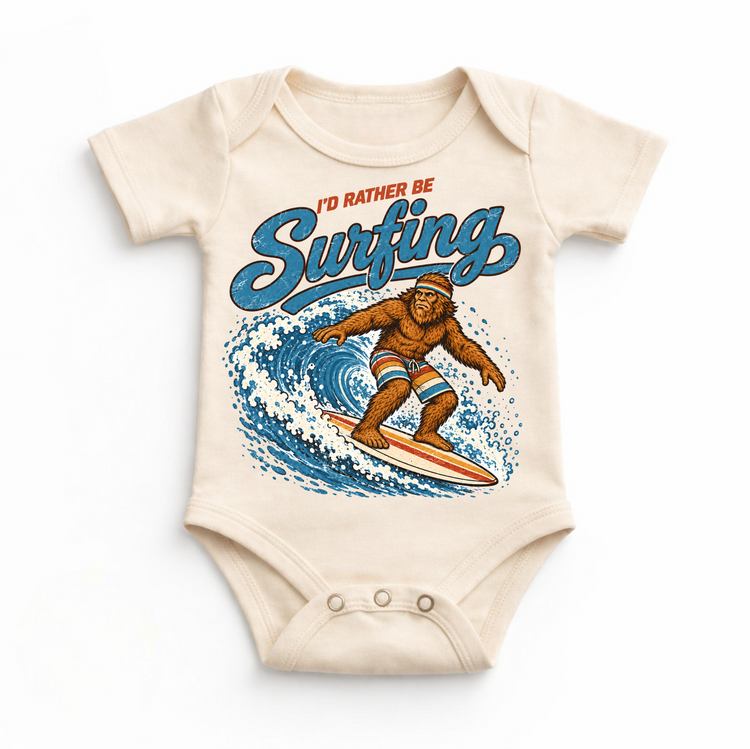 I'd Rather Be Surfing Bigfoot riding a wave design on a natural baby bodysuit