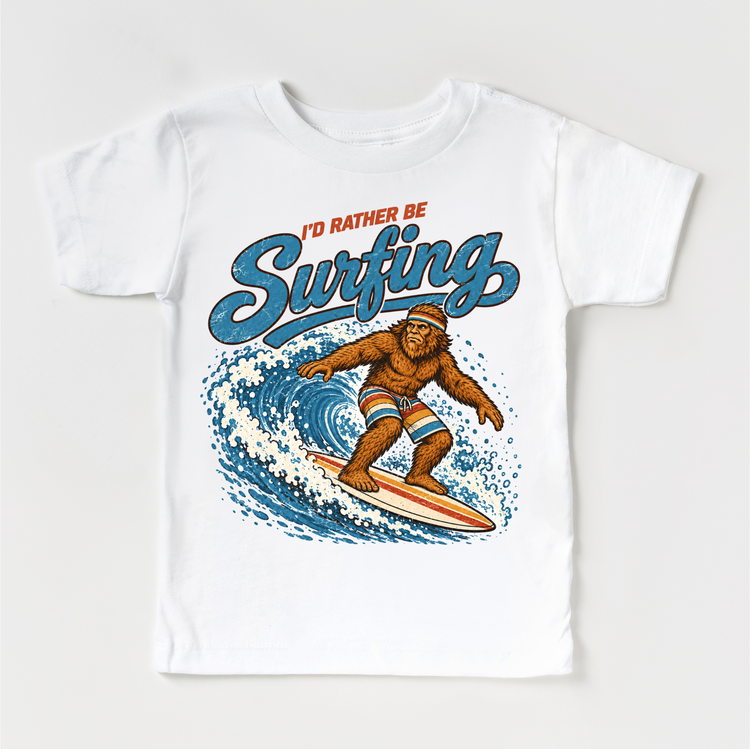 I'd Rather Be Surfing Bigfoot riding a wave design on a white short sleeve tee