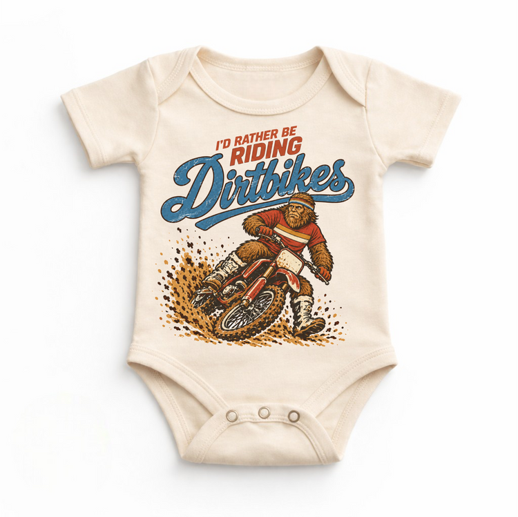 I'd Rather Be Riding Dirtbikes Bigfoot on a dirt bike design on a natural baby bodysuit