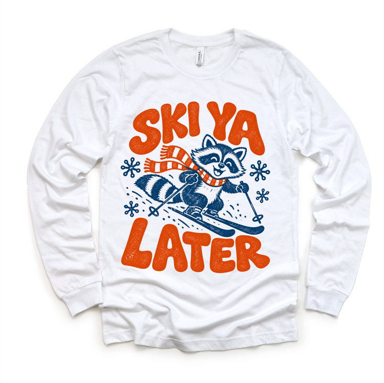 Ski Ya Later skiing raccoon in navy and orange on a white long sleeve tee