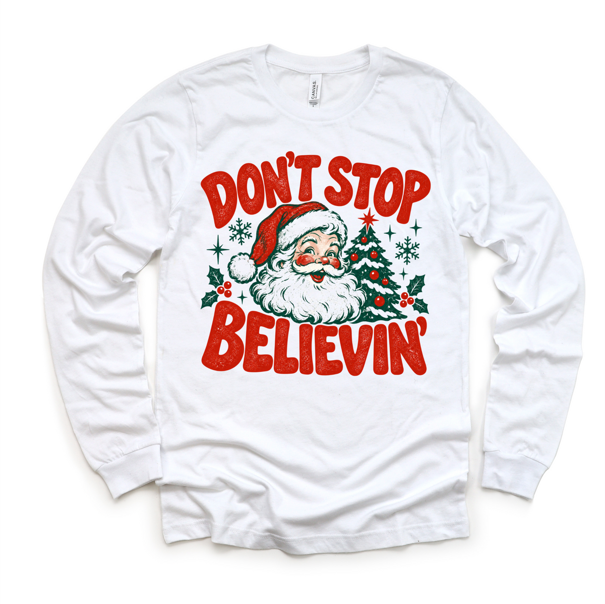 Don't Stop Believin' retro Santa and Christmas tree graphic in red and green on a white long sleeve tee