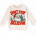 Don't Stop Believin' retro Santa and Christmas tree graphic in red and green on a natural heather sweatshirt