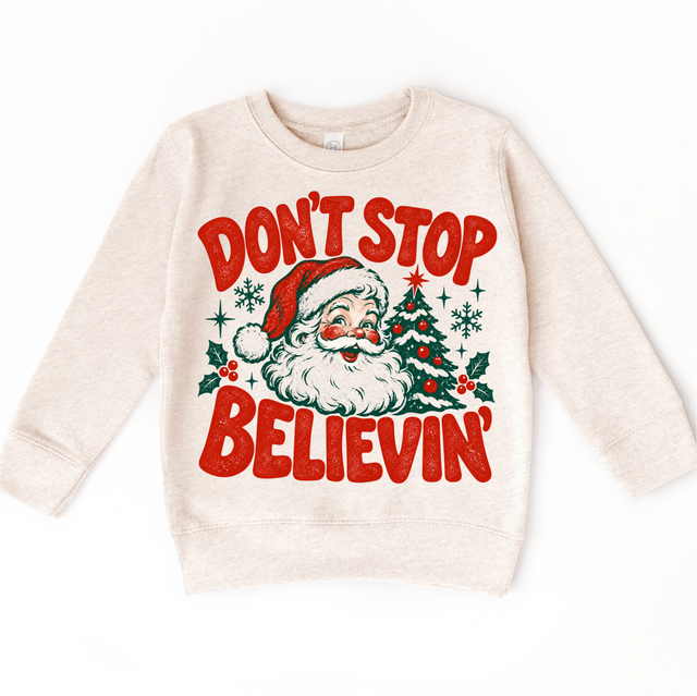 Don't Stop Believin' retro Santa and Christmas tree graphic in red and green on a natural heather sweatshirt