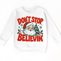 Don't Stop Believin' retro Santa and Christmas tree graphic in red and green on a white sweatshirt