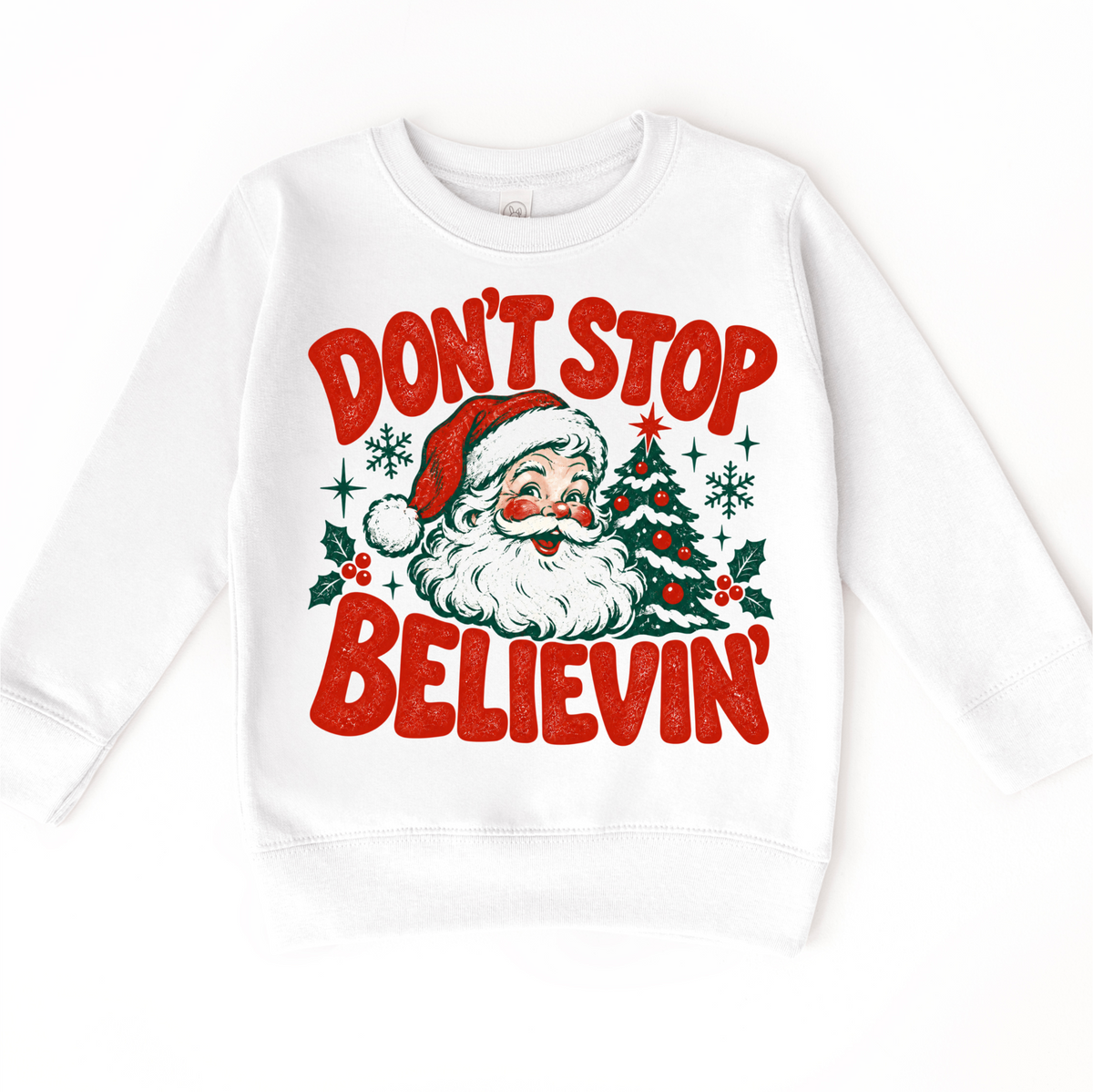Don't Stop Believin' retro Santa and Christmas tree graphic in red and green on a white sweatshirt
