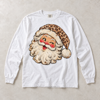 White Comfort Colors long-sleeve T-shirt with vintage winking leopard Santa graphic