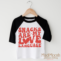 Snacks Are My Love Language Valentine's Day design on a black-accented shirt.