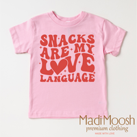 Snacks Are My Love Language Valentine's Day design on a pink garment.
