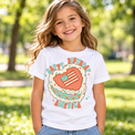 Child wearing a white Happy Birthday America Shirt outdoors
