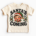 Santa's Coming Christmas graphic on natural tee, front view on white background