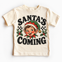 Santa's Coming Christmas graphic on natural tee, front view on white background