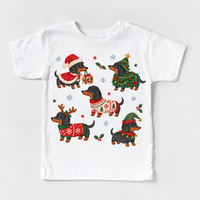 white tee with five dachshunds in Christmas costumes, holly and snowflakes
