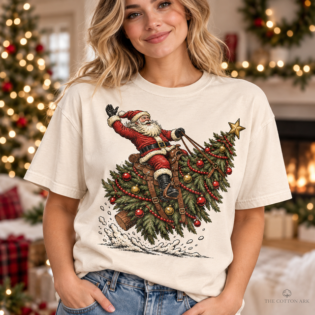 Woman wearing natural Comfort Colors Santa Riding Christmas Tree Shirt