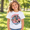 Child wearing a white American Cowgirl Shirt outdoors
