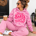 Dear Santa I Can Explain pink camo hoodie styled with pink pants on a porch