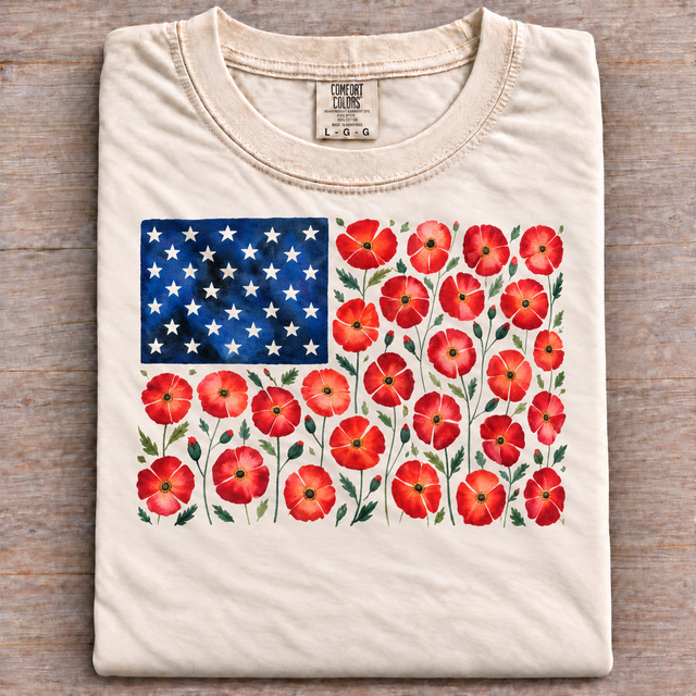 Folded ivory Comfort Colors T-shirt with a red poppy floral American flag graphic