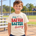 Generated lifestyle mockup of the Hey Batter Batter Swing baseball shirt in Natural at the ballpark.
