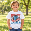 Child wearing a white Howdy America Shirt outdoors