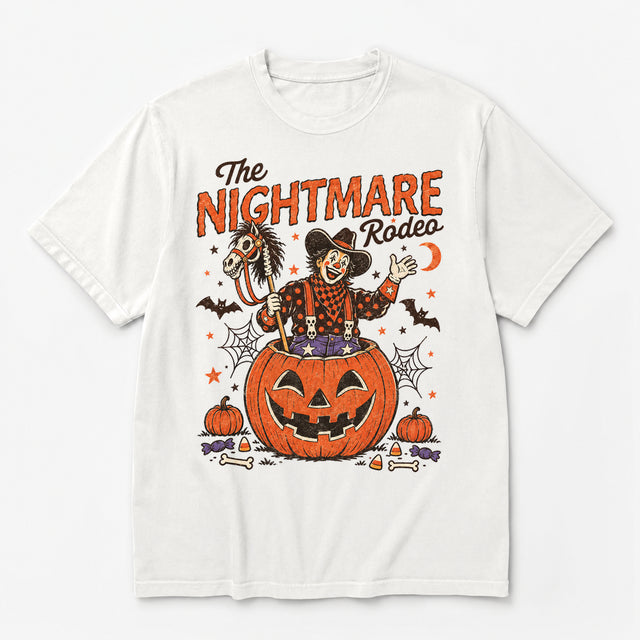 White Comfort Colors T-shirt with The Nightmare Rodeo Halloween design featuring a cowboy clown, orange pumpkin, skeleton hobby horse and bats
