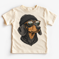 Dachshund wearing a beanie and mountain sunglasses printed on natural tee, front view