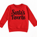 Santa's Favorite Christmas shirt features elegant black lettering with curled details. Shown on red sweatshirt, front view.