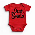 Dear Santa Christmas shirt features black script lettering, a Santa hat and stars. Shown on red onesie, front view.