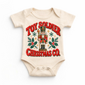natural baby bodysuit with vintage nutcracker, holly and Toy Soldier Christmas Co. lettering