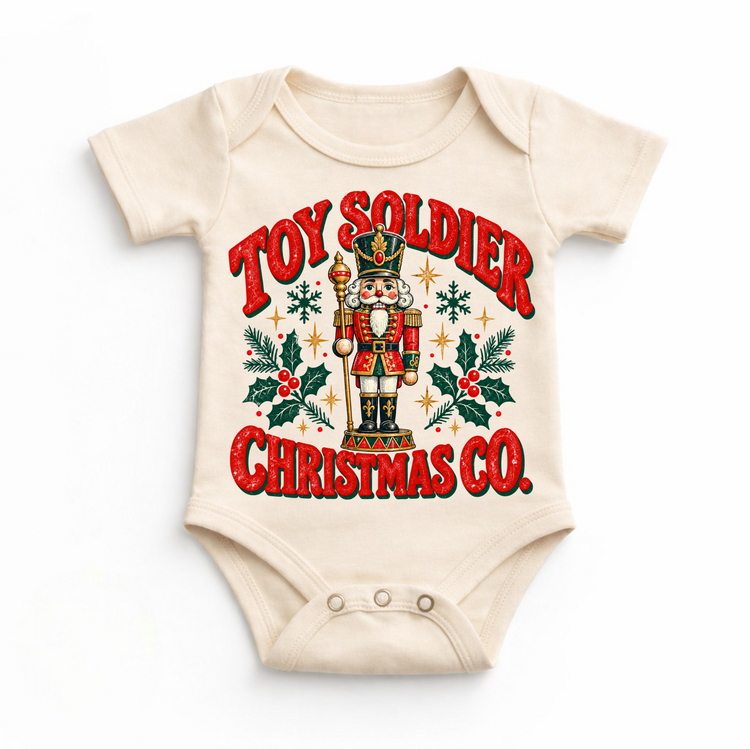 natural baby bodysuit with vintage nutcracker, holly and Toy Soldier Christmas Co. lettering