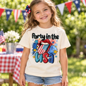 Girl wearing a Natural Party In The USA tee at a Fourth of July backyard picnic.