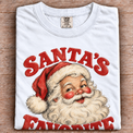 Santa's Favorite vintage Christmas graphic on folded white tee