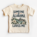 Someone in Alabama Loves Me design on a natural beige short sleeve T-shirt