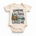 Someone in Alaska Loves Me design on a natural beige baby bodysuit