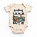 Someone in Arkansas Loves Me design on a natural beige baby bodysuit
