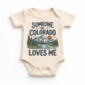 Someone in Colorado Loves Me design on a natural beige baby bodysuit