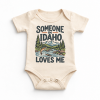 Someone in Idaho Loves Me design on a natural beige baby bodysuit