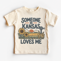 Someone in Kansas Loves Me design on a natural beige short sleeve T-shirt