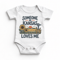 Someone in Kansas Loves Me design on a white baby bodysuit