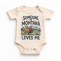 Someone in Montana Loves Me design on a natural beige baby bodysuit