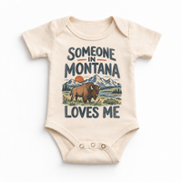Someone in Montana Loves Me design on a natural beige baby bodysuit