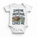 Someone in Montana Loves Me design on a white baby bodysuit