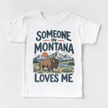 Someone in Montana Loves Me design on a white short sleeve T-shirt