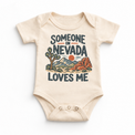 Someone in Nevada Loves Me design on a natural beige baby bodysuit