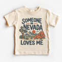 Someone in Nevada Loves Me design on a natural beige short sleeve T-shirt