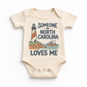 Someone in North Carolina Loves Me design on a natural beige baby bodysuit