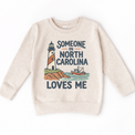 Someone in North Carolina Loves Me design on a natural beige sweatshirt