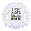 Someone in North Carolina Loves Me design on a white long sleeve T-shirt