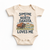 Someone in North Dakota Loves Me design on a natural beige baby bodysuit